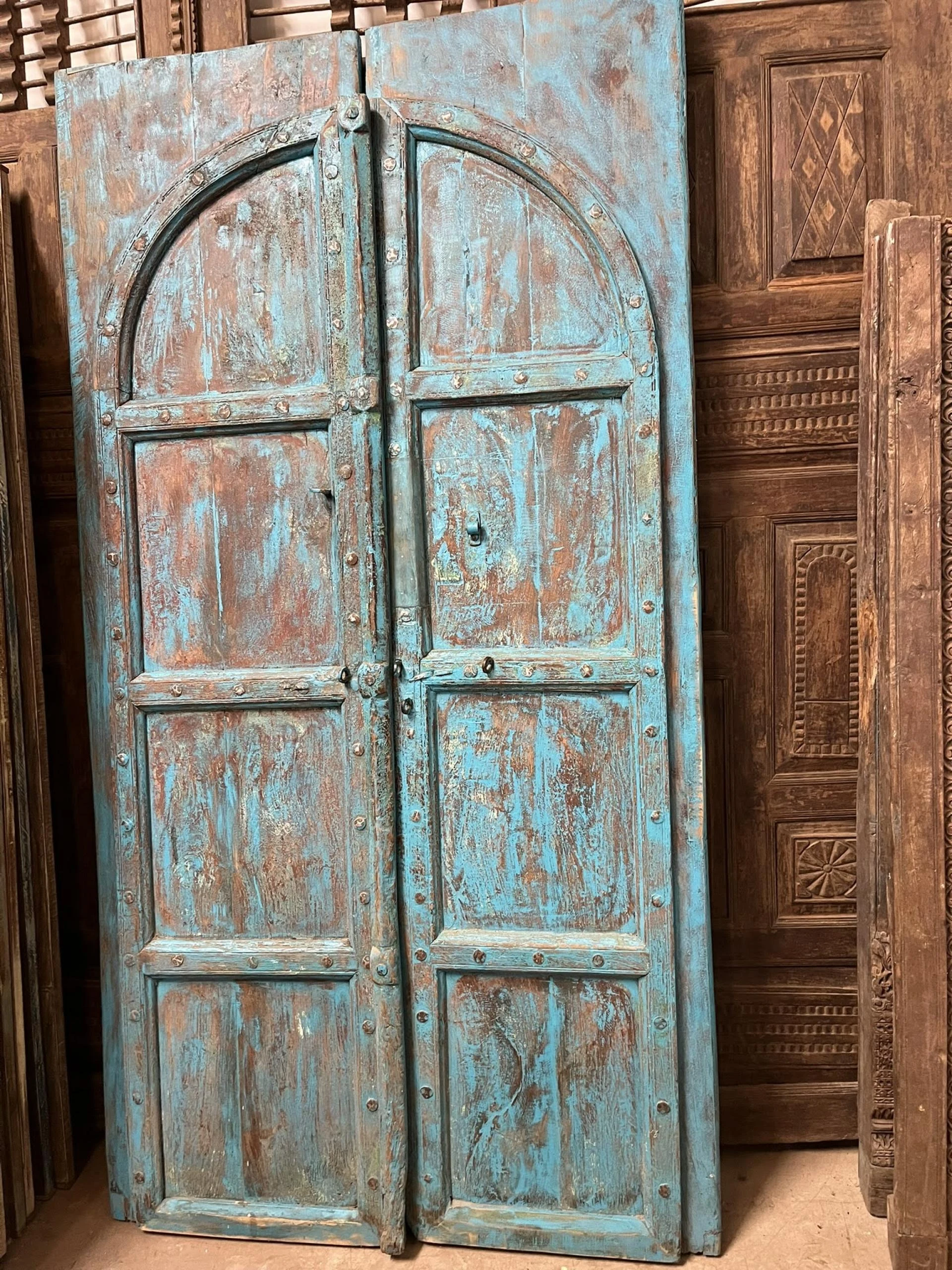 More is More: Moody Blue Carved Doors in Mogul Interior Wellness Decor