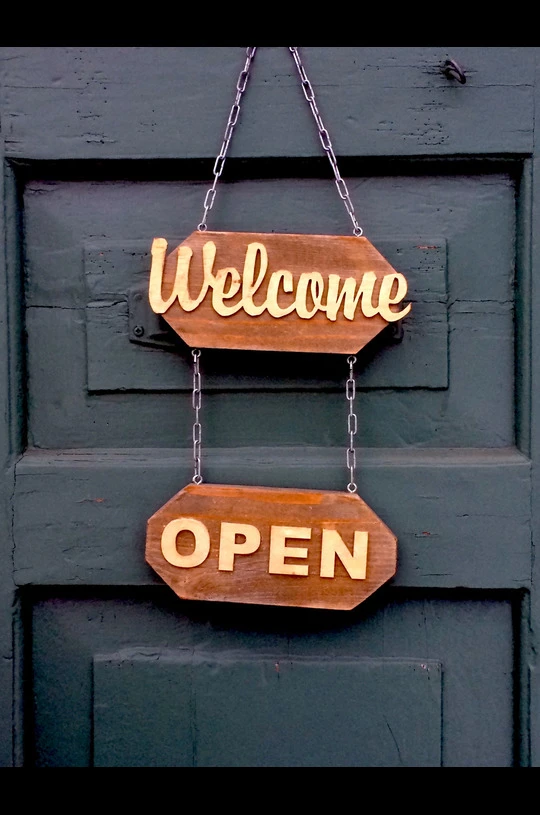 How Hanging Wooden Signs Enhances Your Property’s Curb Appeal