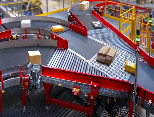 How Conveyor System Solutions Support High-Volume Warehouses 