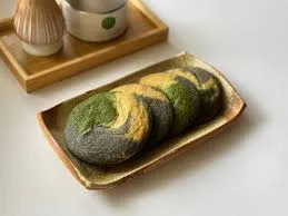 Gluten-free matcha black sesame mad cookies on a rustic plate, garnished with black sesame seeds