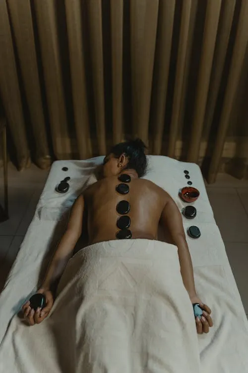 a person getting a hot stone massage 