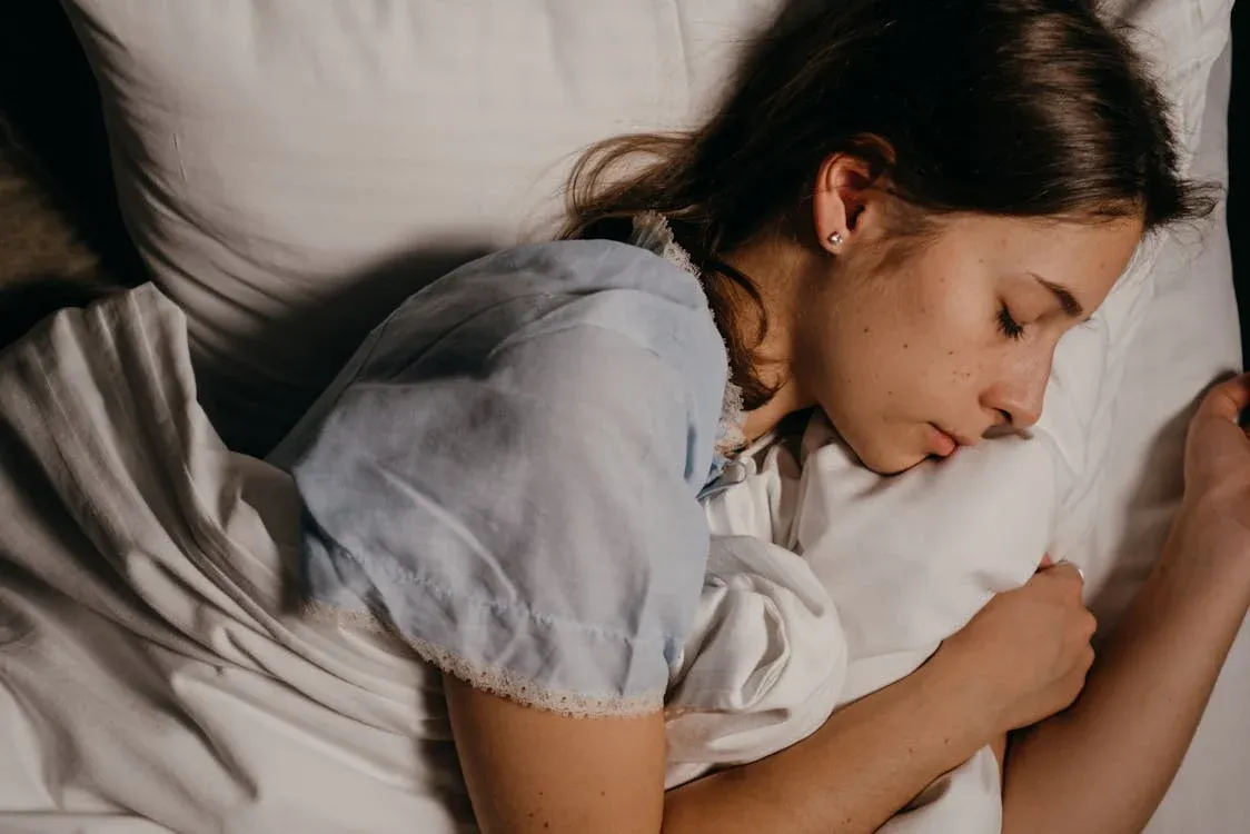 teenage girl sleeping on a pillow, demonstrating natural sleep posture during monitoring