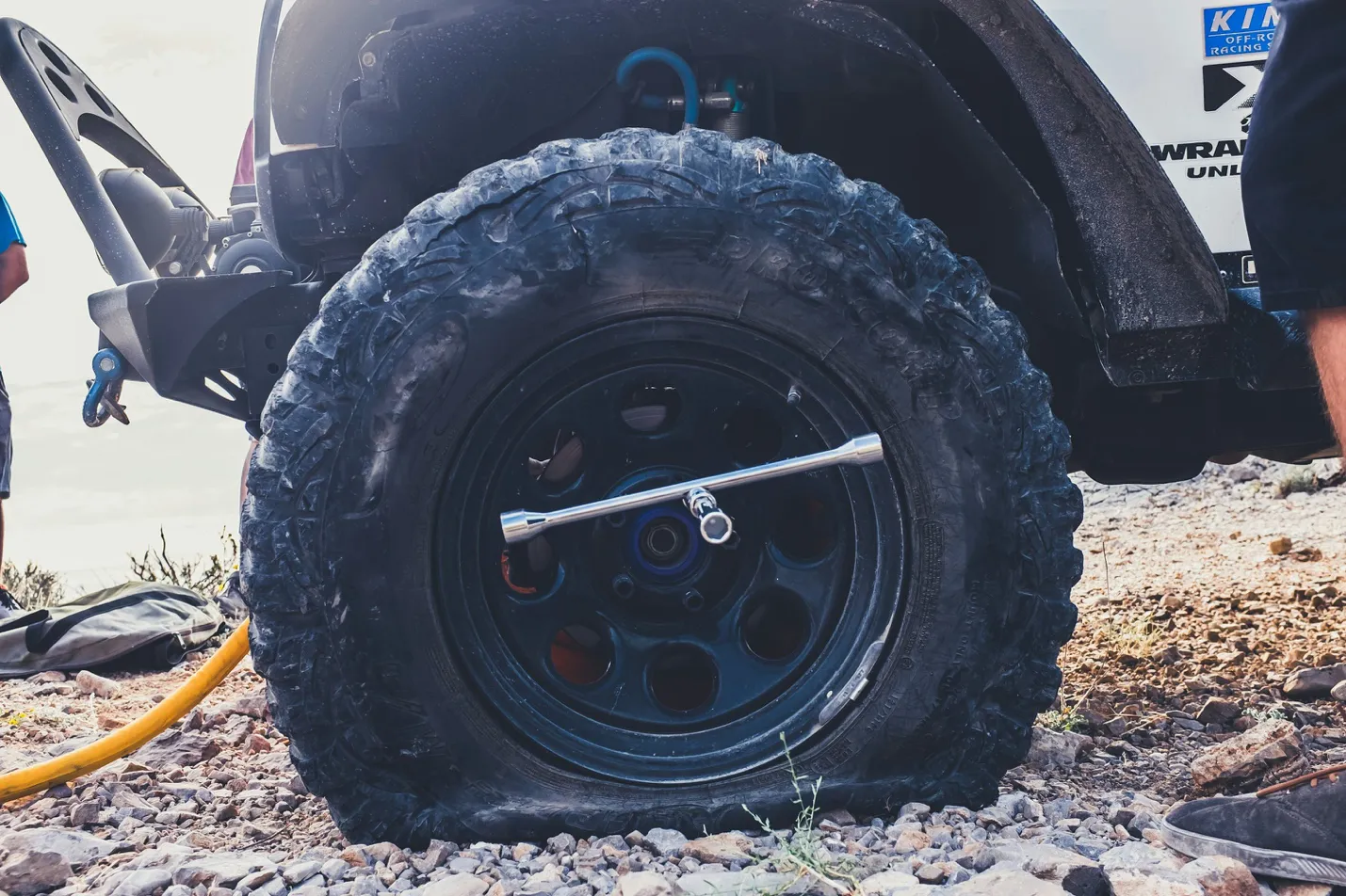 Technician fixing a flat tire using professional roadside service tools
