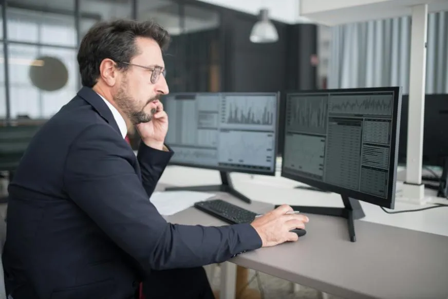 forensic expert analyzing digital data on multiple screens
