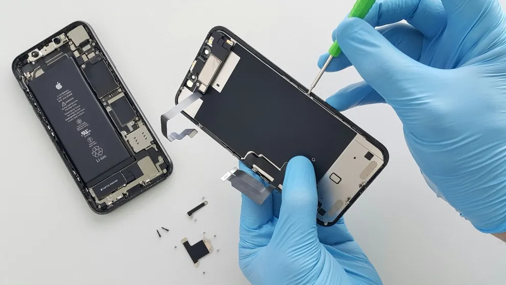 technician extracting data from a smartphone for forensic analysis