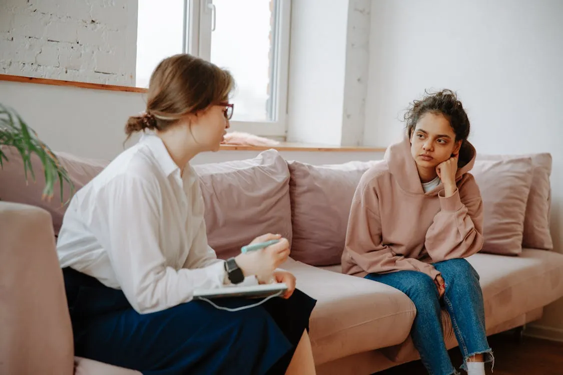 A support worker talking to a teen