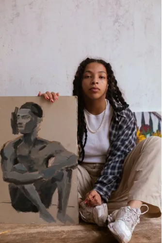 Girl holding a finished painting in an art studio