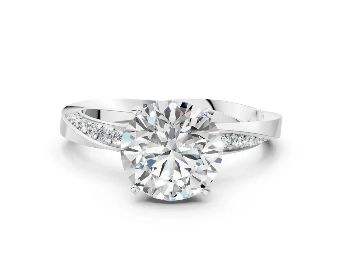White Gold Round Cut Diamond Engagement Ring with Side Stone Accents and Four-Prong Setting: Understated Brilliance
