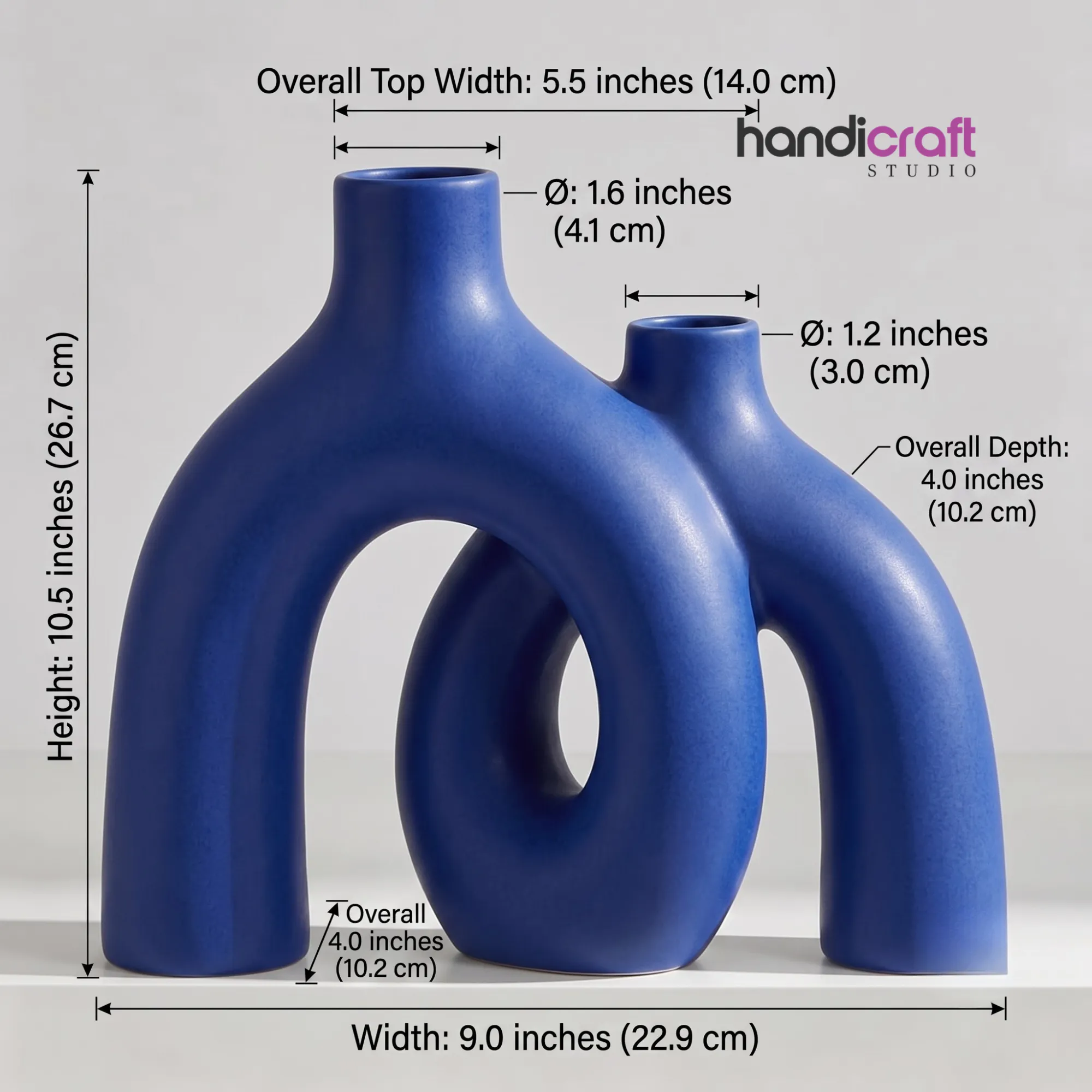 Handmade ceramic hug donut vase in a matte blue finish, featuring an abstract interlocking circle shape on a linen runner.