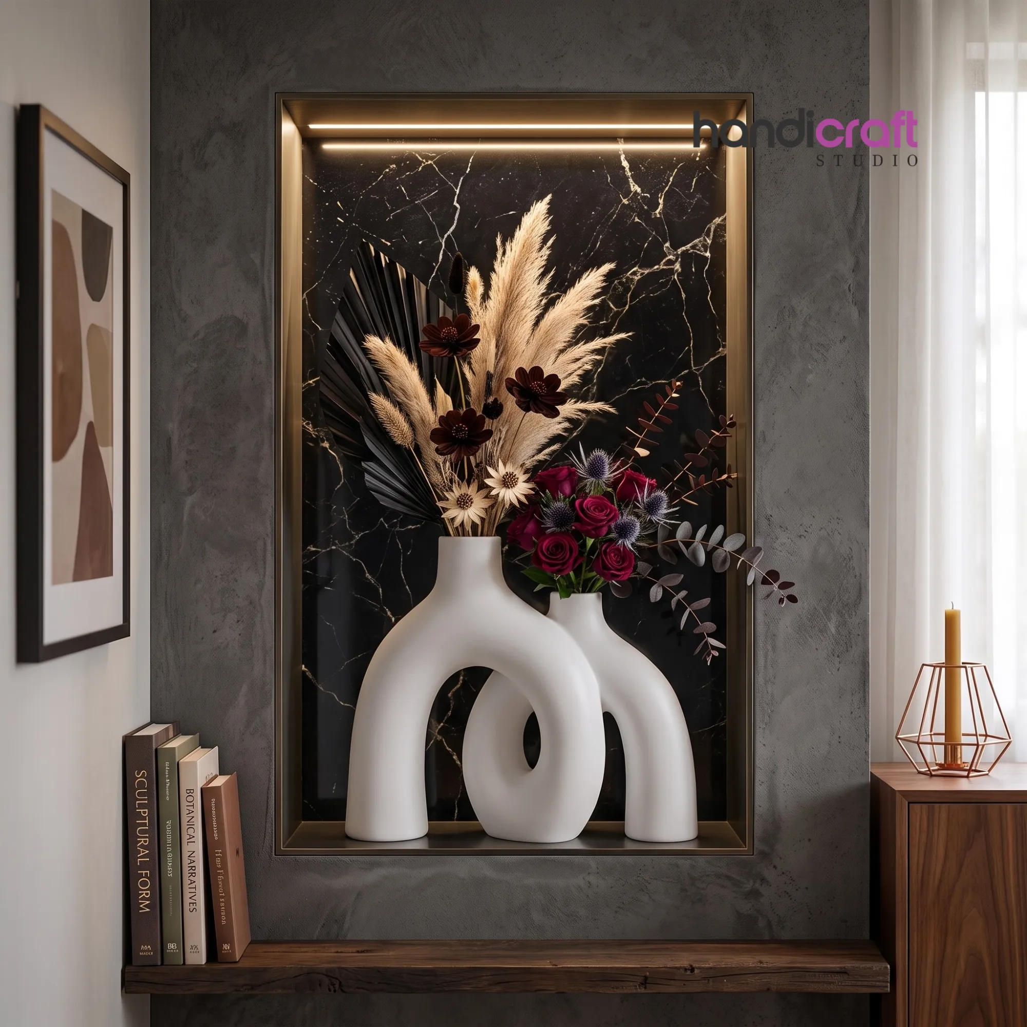 Interlocking white ceramic hug vase filled with dried pampas grass and red roses inside an illuminated marble wall niche from Handicraft Studio.