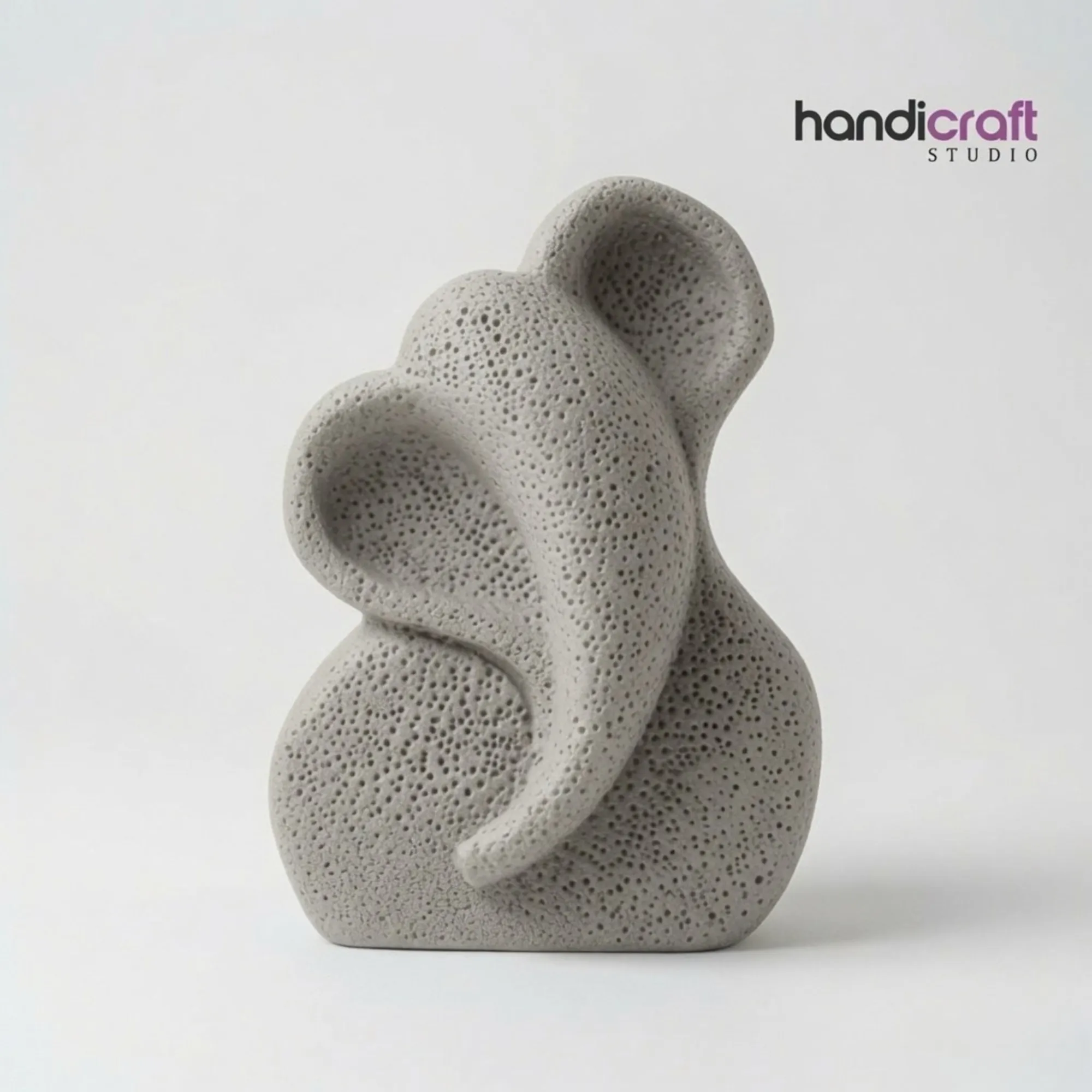 Minimalist ceramic Ganpati murti with light porous texture finish