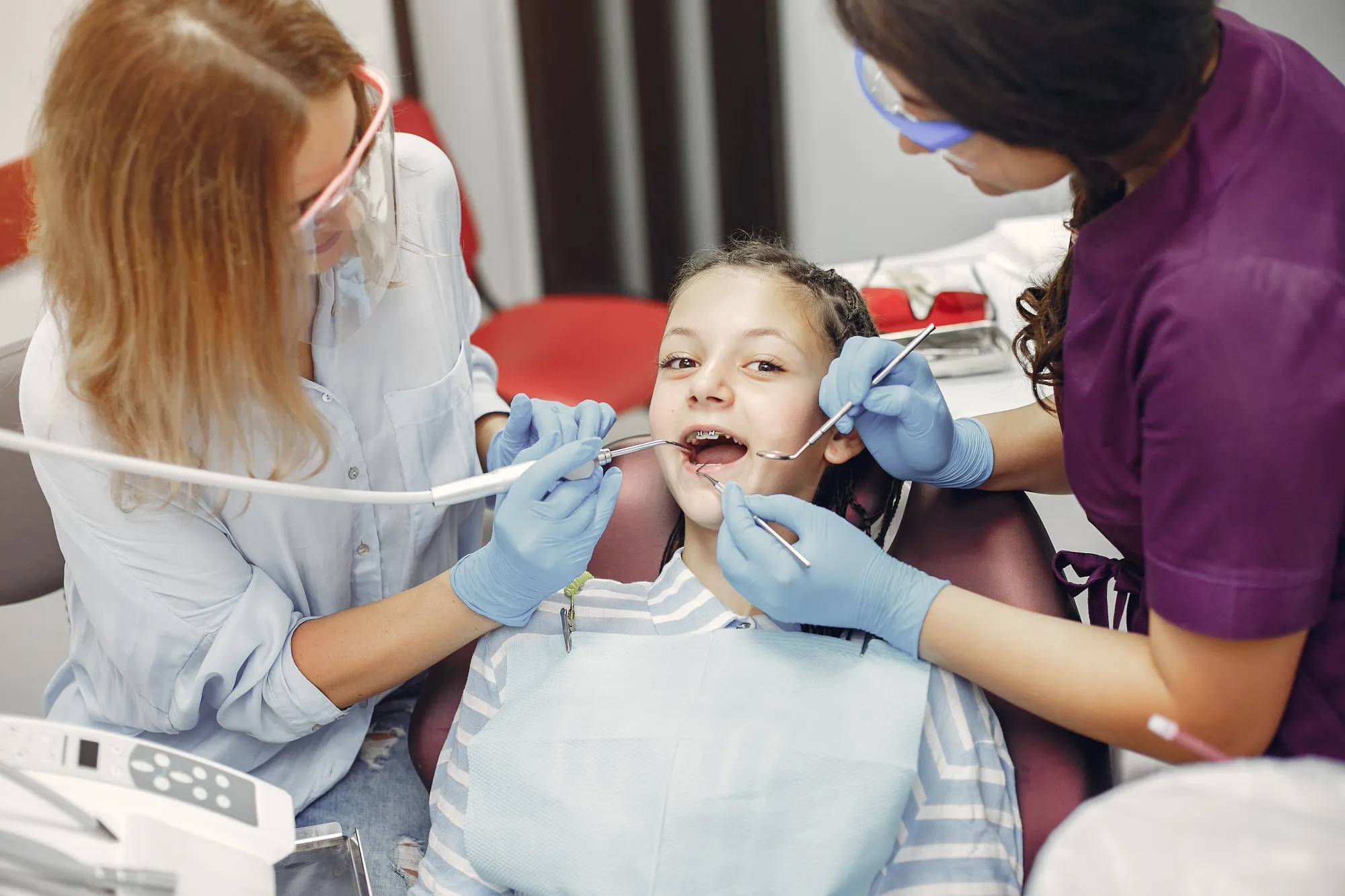Young child in dental chair receiving nitrous oxide through nasal mask during examination