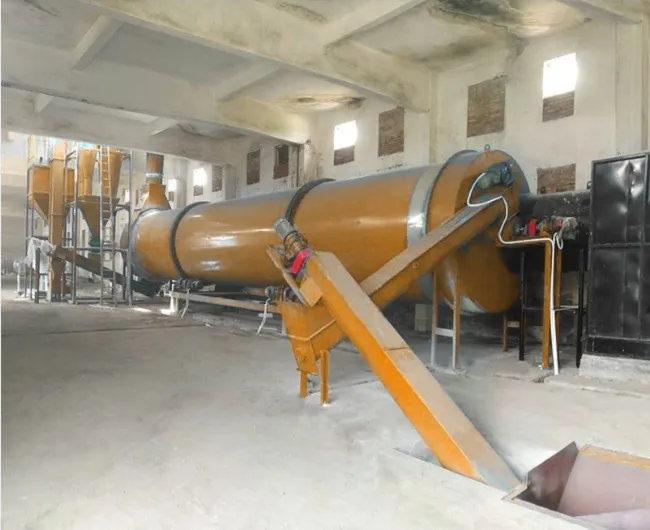 Industrial rotary dryer installed in a processing plant for drying beet pulp and other bulk materials.