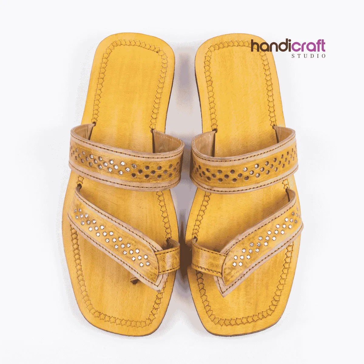 Traditional mustard yellow Chamba leather chappal for women with intricate punch work and decorative toe loop.