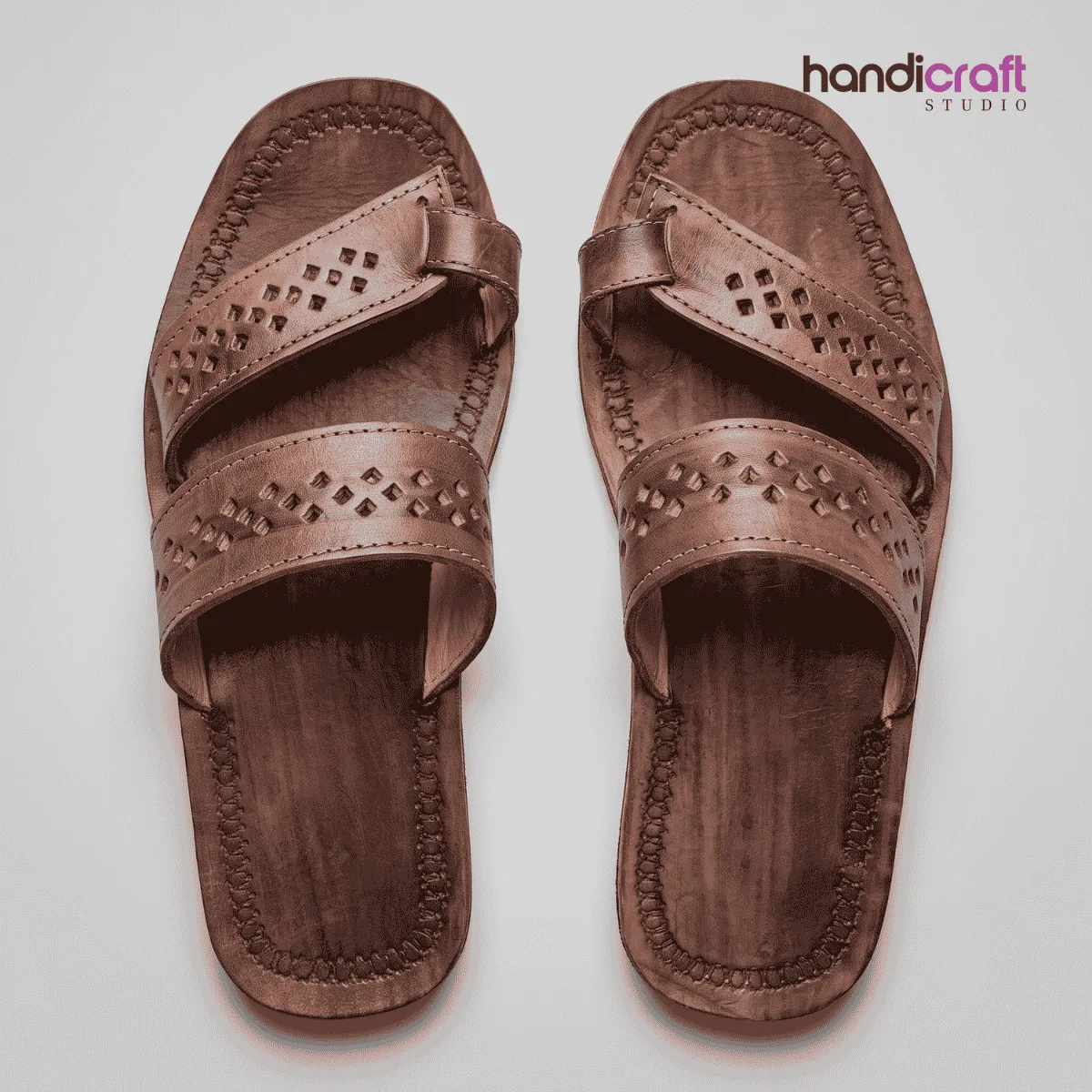 Traditional dark brown leather Chamba chappal featuring double-cross straps with diamond geometric cutwork patterns.