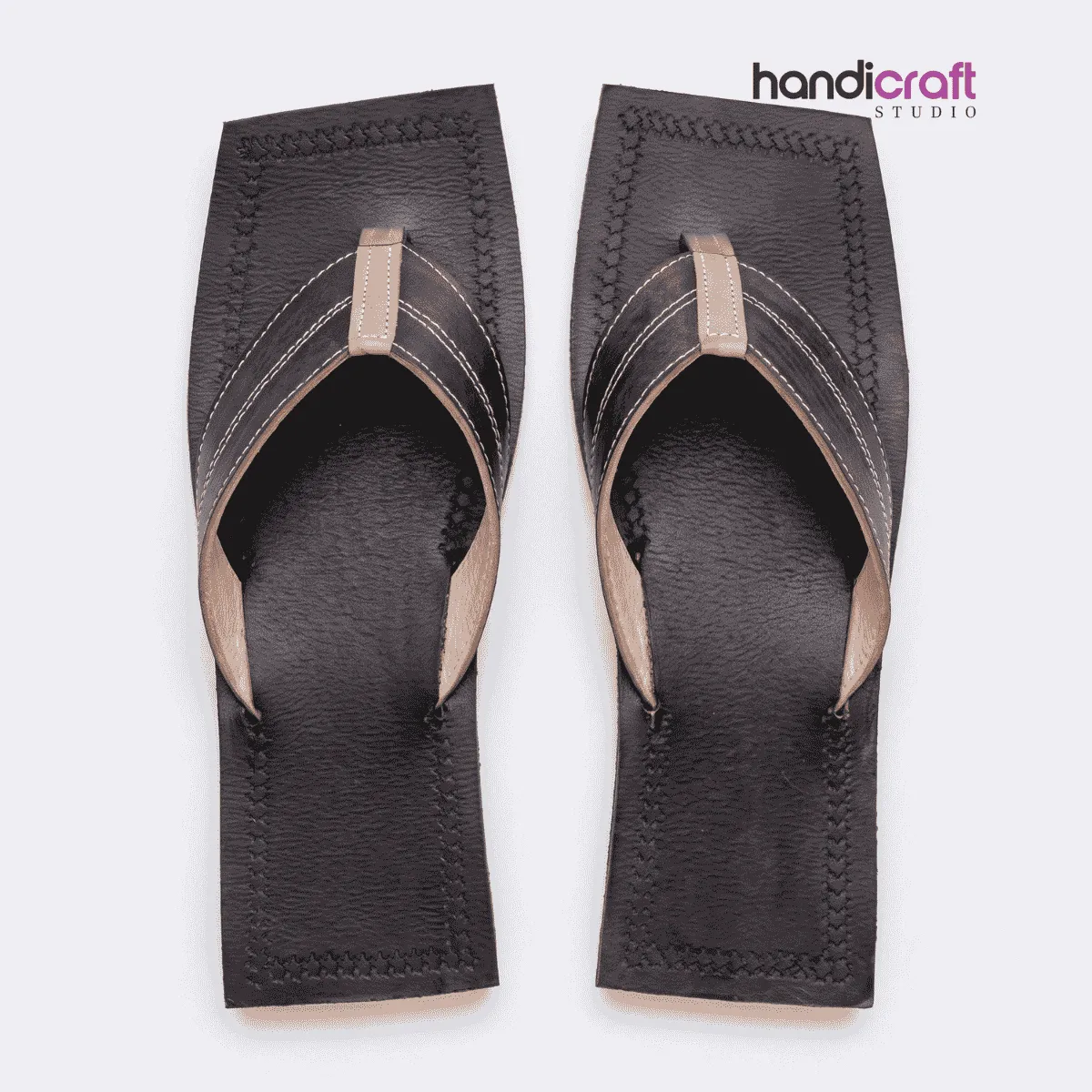 Overhead layout of handcrafted dark brown leather thong-style slippers featuring a distinctive rectangular square-toe sole, reinforced stitching along the edges, and a broad beige-lined V-strap.