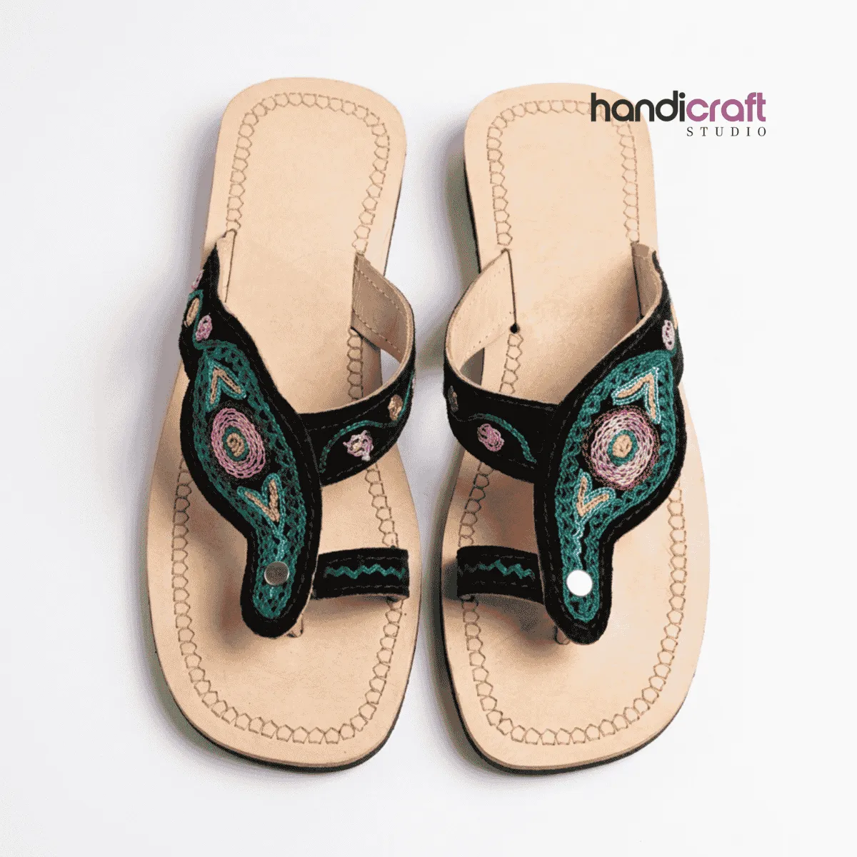 Authentic light tan Chamba leather chappal for women with fine green and pink floral hand embroidery on black velvet strap.