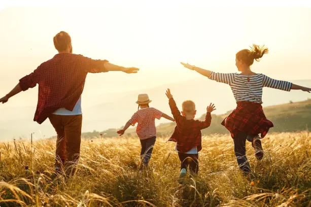  A happy family running around in a field. 