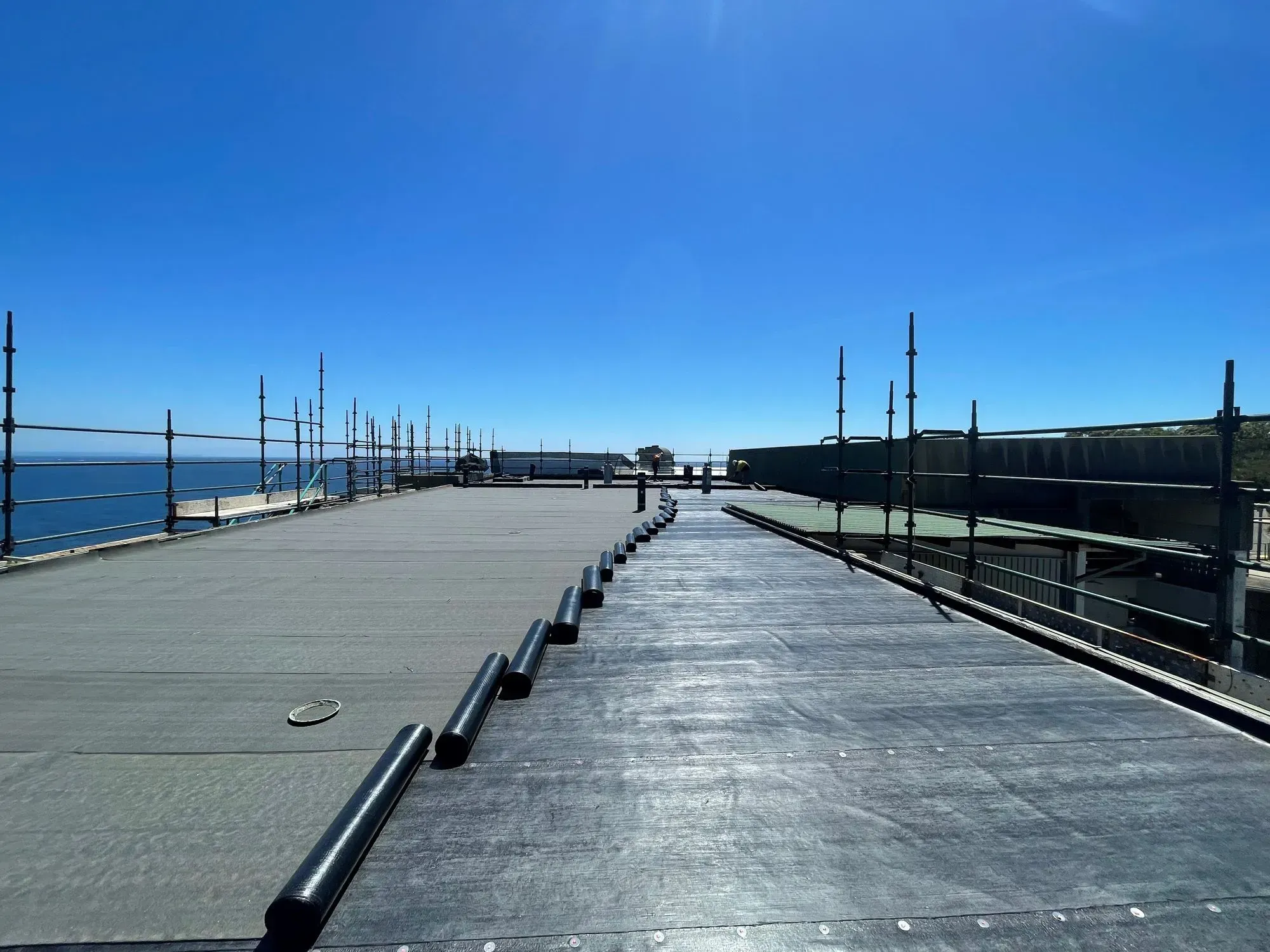 How does torch on membrane waterproofing seal a slab by heat-fusing bitumen sheets to a primed surface?