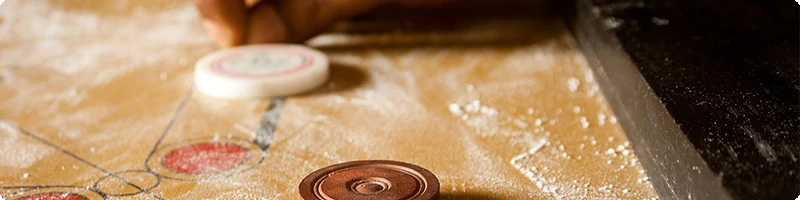 What is the aim of Carrom?