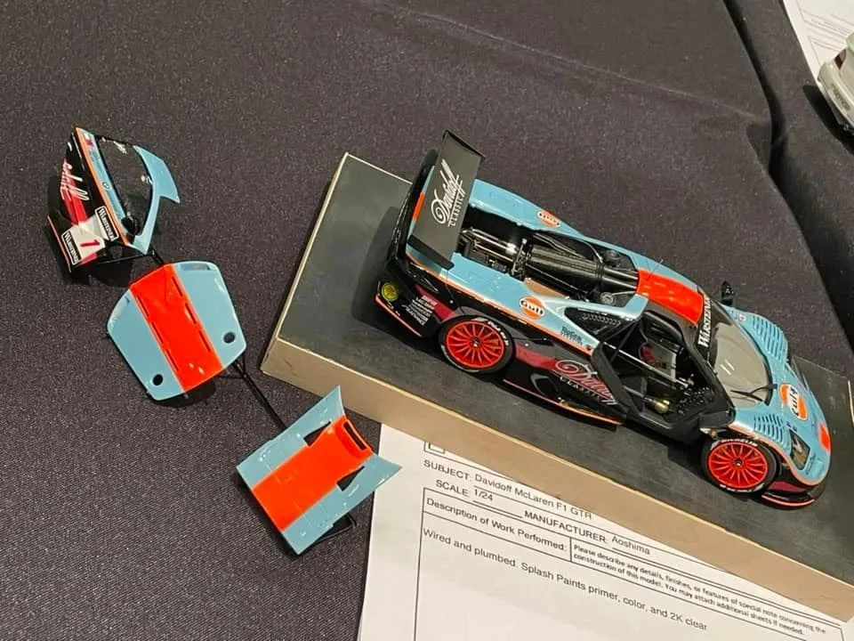 What are the differences between plastic, resin, and metal model car kits?