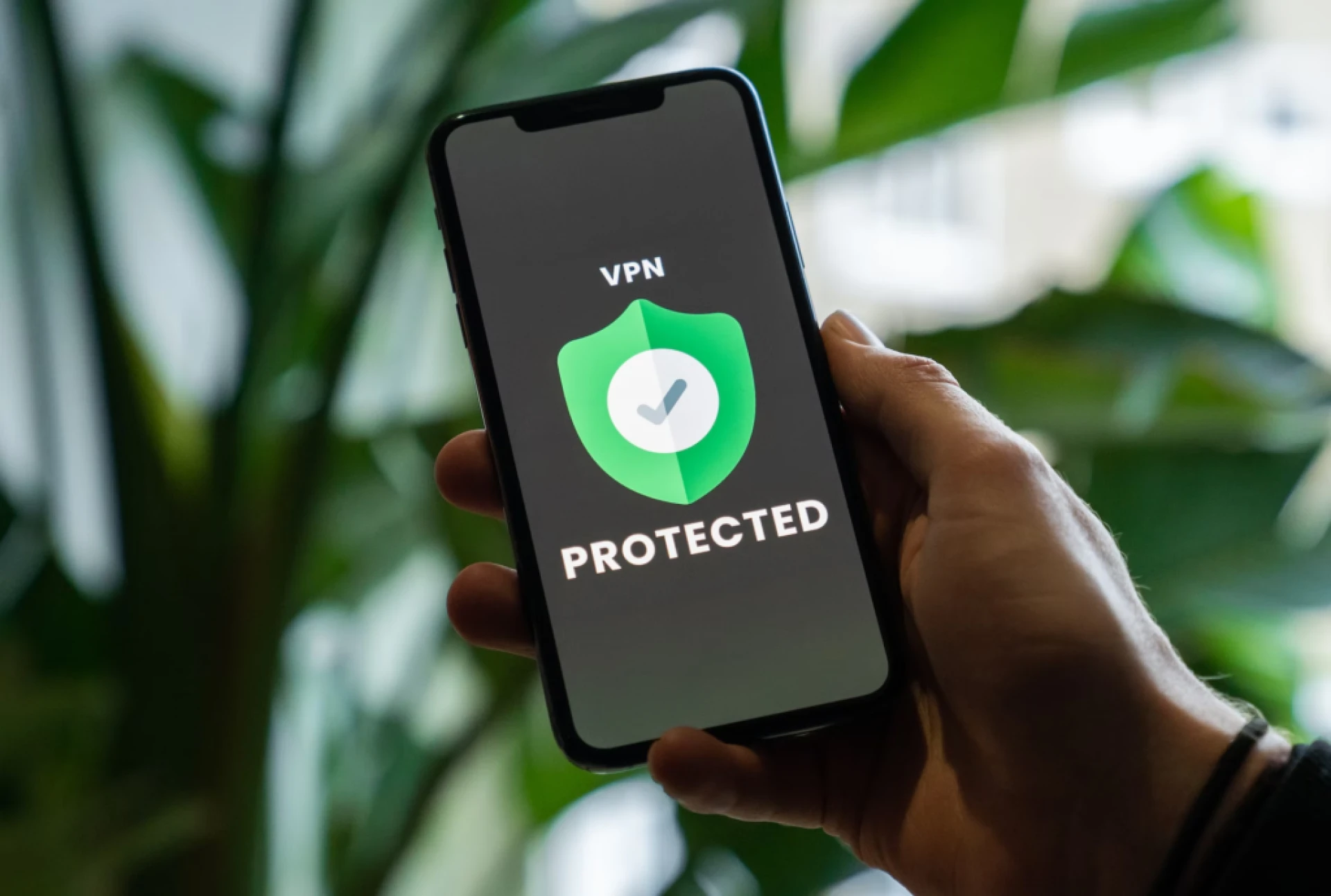 iPhone with VPN service enabled in hand- VPN extension for Chrome