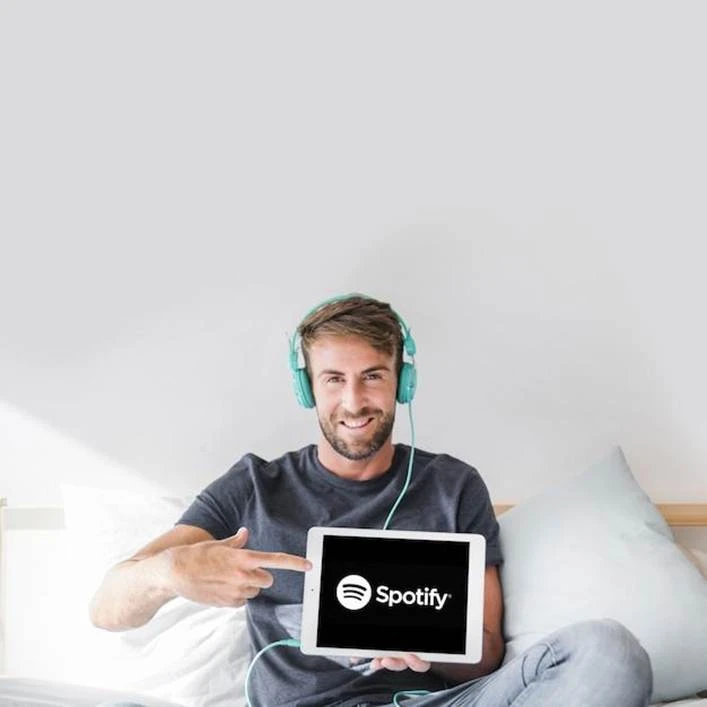 https://img.freepik.com/free-photo/young-man-holding-tablet-with-spotify-app_23-2147987808.jpg