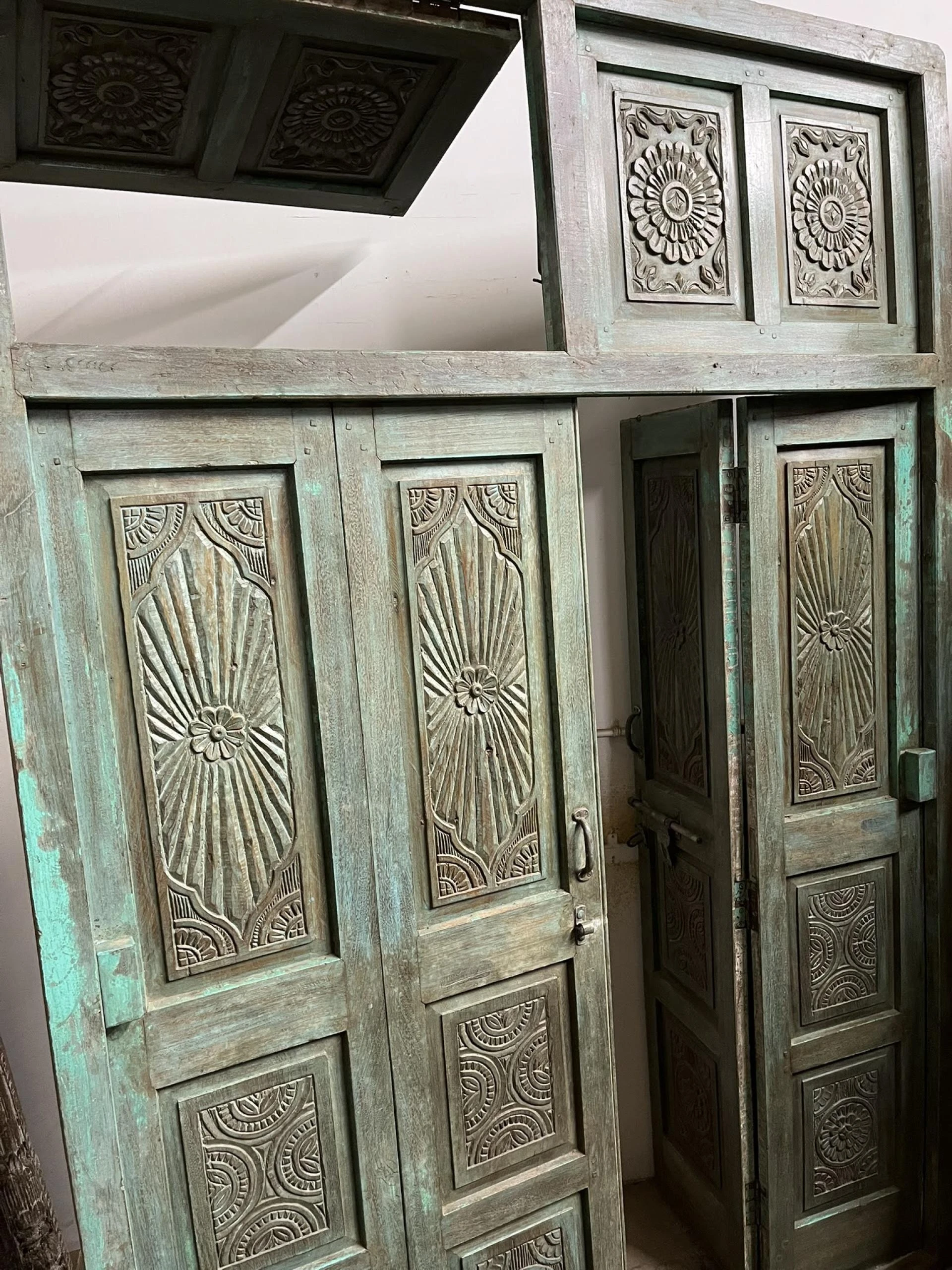 More is More: Moody Blue Carved Doors in Mogul Interior Wellness Decor