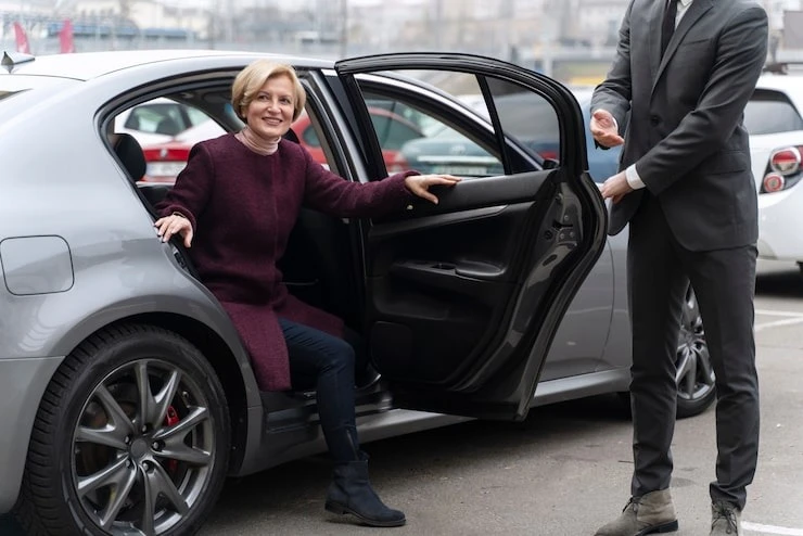 taxi driver and female client interacting in a formal way