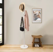 A coat rack with a hat and a bag on itAI-generated content may be incorrect.