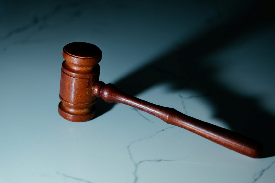 A wooden gavel on a marble surface