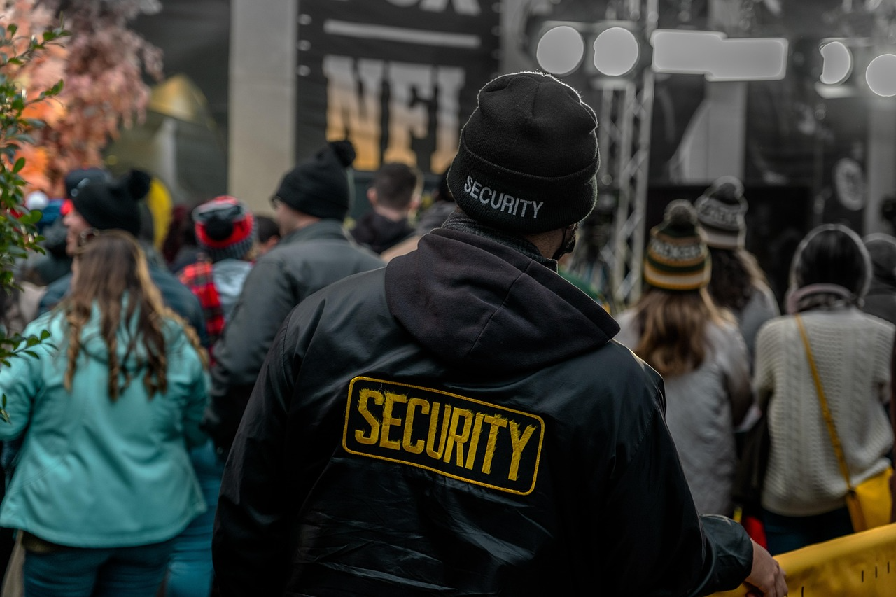 a security guard managing a crowd outside a venue