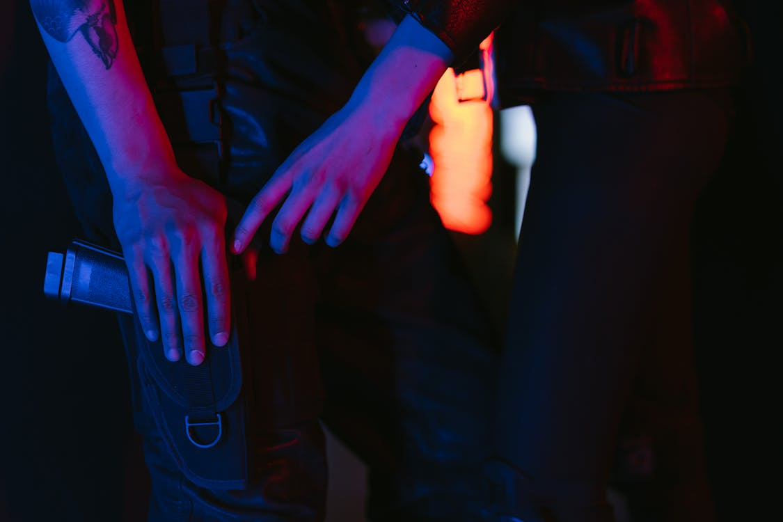 close-up of a gun on an SIA door supervisor outside a nightclub
