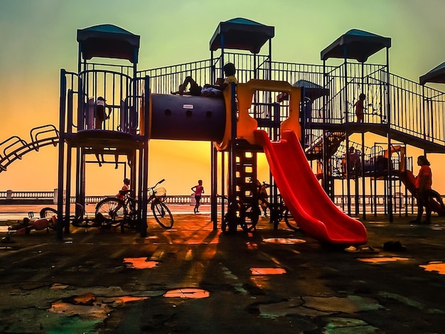 children playing on playground with equipment 