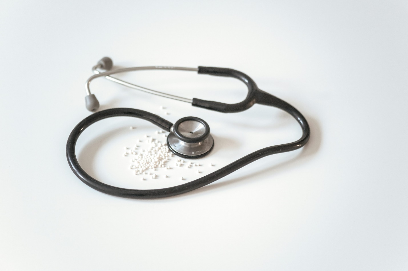 A black colored stethoscope over dust particles.