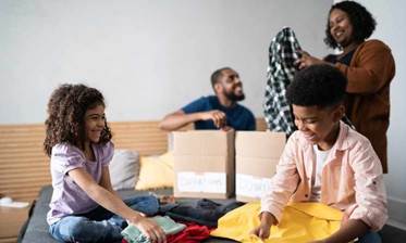 https://www.jkmoving.com/app/uploads/2024/06/Family-sorting-clothes-for-donation-aspect-ratio-750-450.jpg