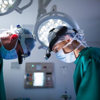 surgeons-wearing-surgical-loupes-while-performing-operation_107420-64896-94305ad7