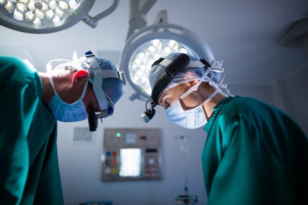 surgeons-wearing-surgical-loupes-while-performing-operation_107420-64896-94305ad7