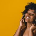 nude-young-african-american-woman-enjoying-music-headphones-studio_23-2148183307-53982679