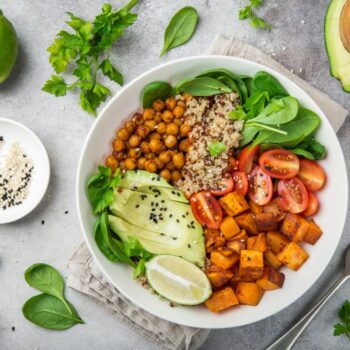 vegan-meal-with-chickpeas-quinoa-sweet-potato-avocado-lime-and-high-fiber-vegetables-and-legumes-for-pcos-diet-ac987974