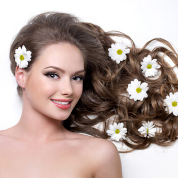 smiling-woman-with-beautiful-long-hair-wna-flowers-it-white (1)-e1ccbbf4