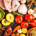 balanced-diet-food-background-healthy-ingredients-dark-bac-fruits-vegetables-meat-cereals-nuts-top-view-127593996-1b72830f