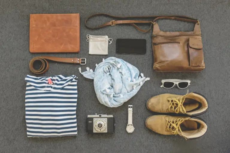Several different fashion accessories for someone about to travel. 
