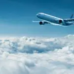 Airplane-flies-above-clouds-air-travel-212abccf