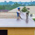 Group-of-commercial-roofing-workers-installing-a-metal-roof-d25124ca