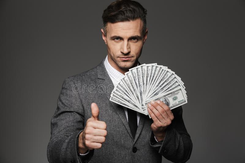 photo-rich-man-s-business-suit-holding-fan-cash-money-photo-rich-man-s-business-suit-holding-fan-cash-money-115311085-2df0e724