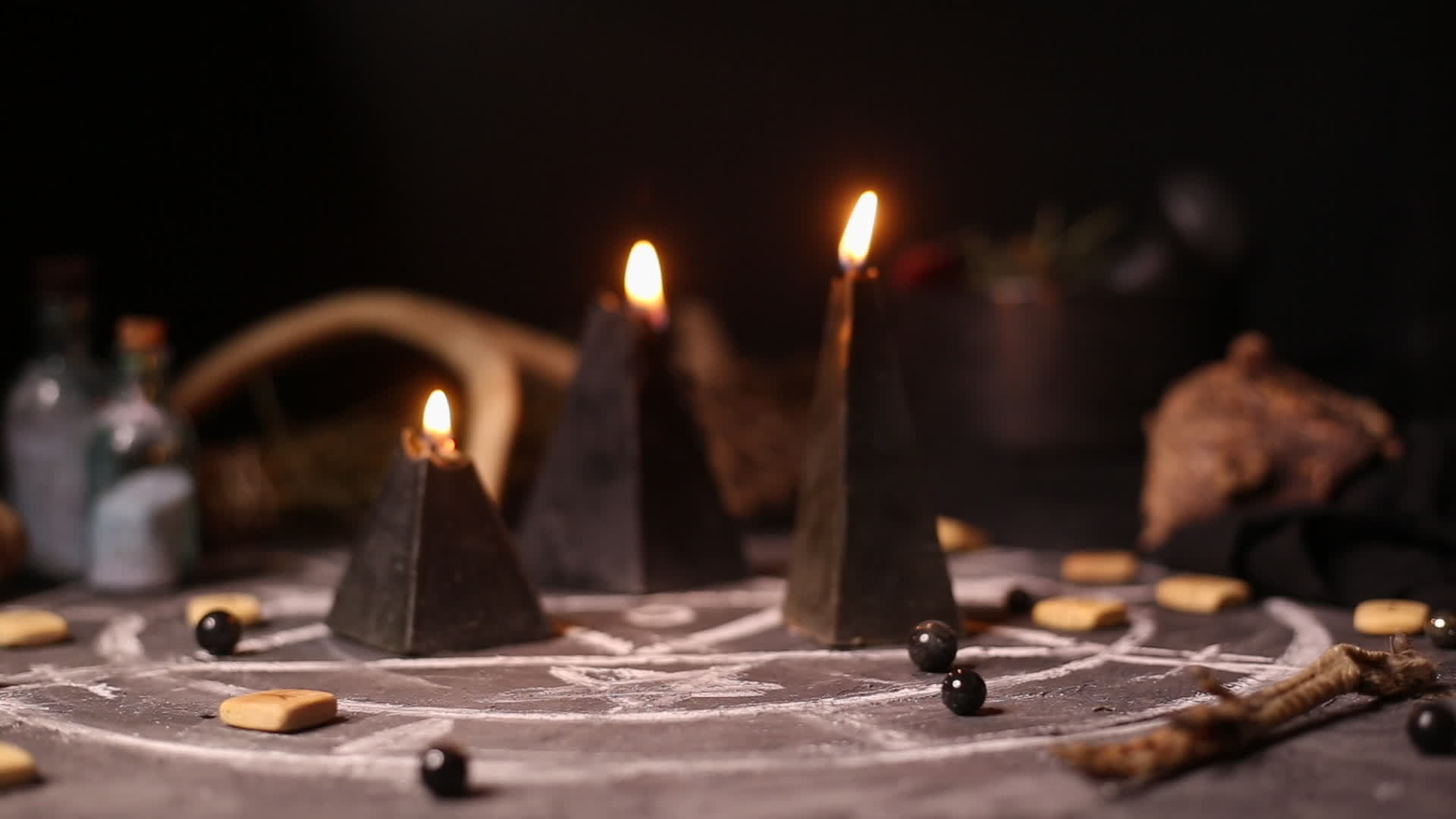black-magic-candles-burn-smoke-on-the-background-of-the-magical-attributes-of-black-art-halloween-concept-video-dedf5238