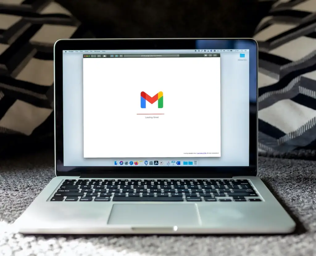 Macbook pro on a table with Gmail opening — Email marketing tools for free
