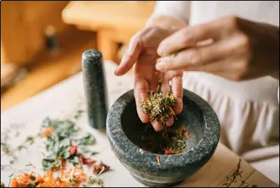 A woman mixing herbs