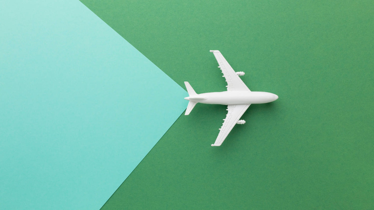top-view-white-plane-green-background (1)